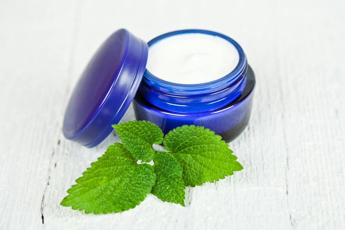 Close-up of moisturizing product scented lotion body that in elegant jar with botanical ingredients visible